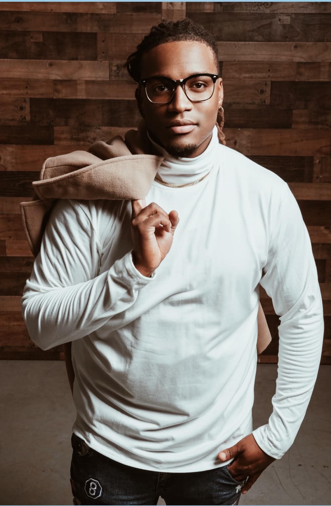 Des the Brand Builder, standing in a studio portrait
